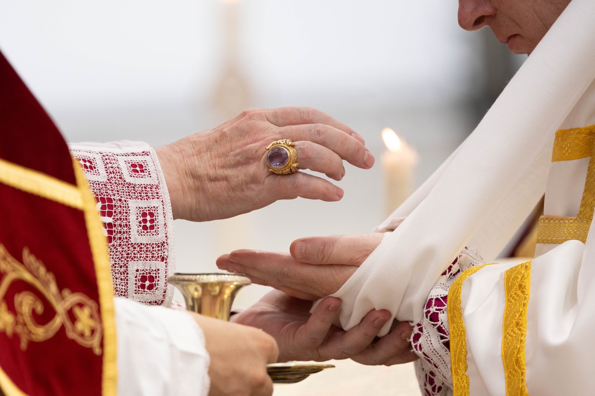 A bishop anoints the hands of the newly …